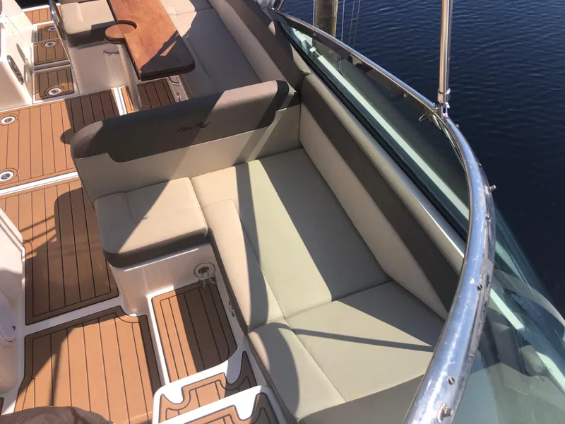 Slide: The Image of 2014 Sea Ray 370 Venture boat interior with cushioned seating and wooden flooring. - 28