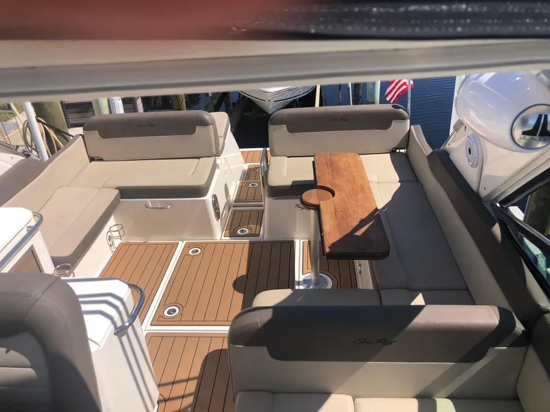 Slide: The Image of 2014 Sea Ray 370 Venture boat interior with seating and wooden table. - 29