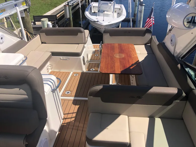 Slide: The Image of 2014 Sea Ray 370 Venture boat interior with seating and wooden table. - 30