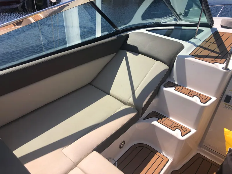 Slide: The Image of 2014 Sea Ray 370 Venture interior with beige seating and wooden steps. - 31