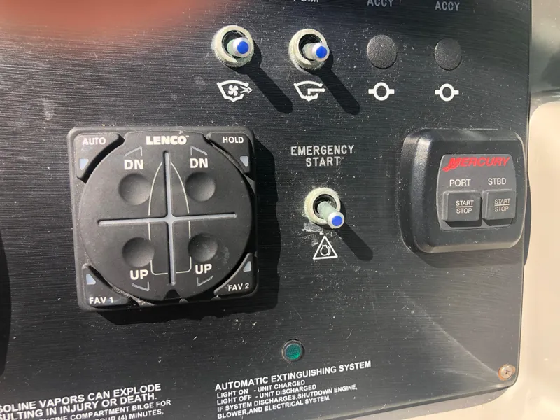 Slide: The Image of Control panel of a 2014 Sea Ray 370 Venture boat with emergency start and trim controls. - 37