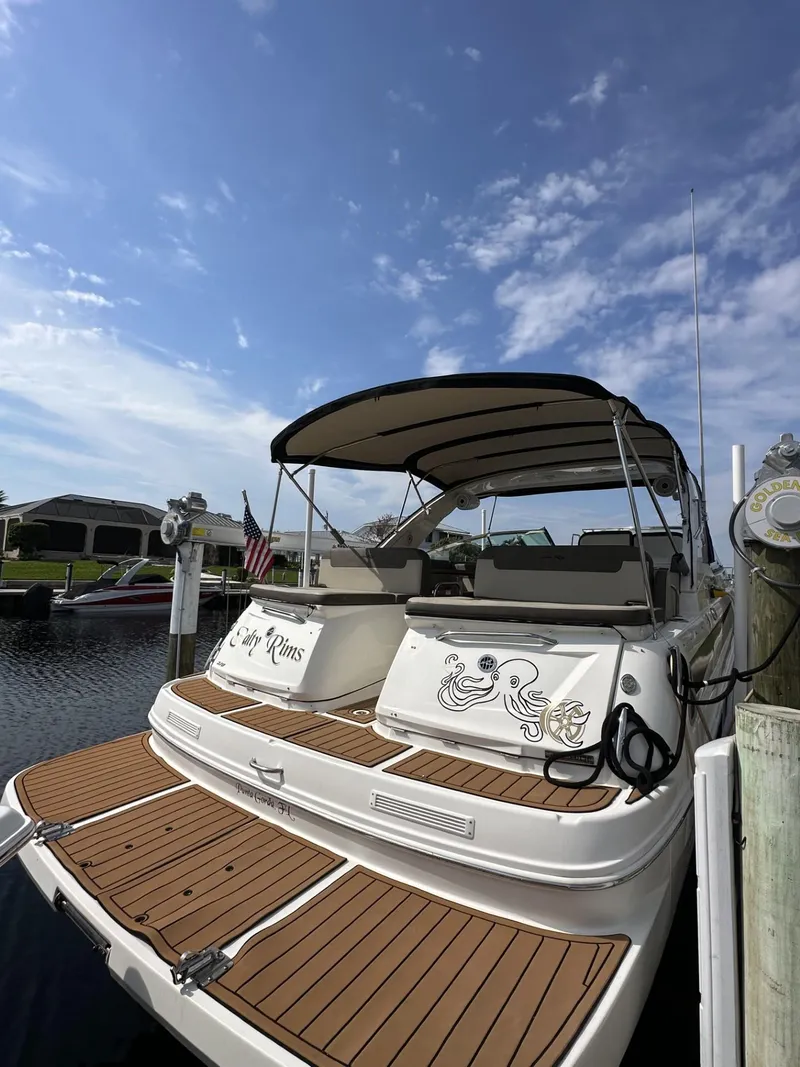 Slide: The Image of 2014 Sea Ray 370 Venture docked under a clear blue sky. - 4