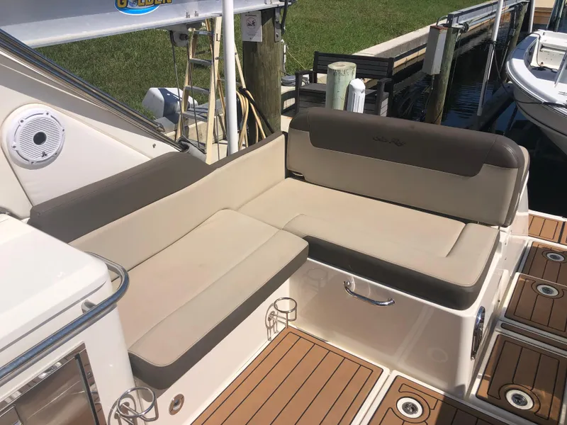 Slide: The Image of 2014 Sea Ray 370 Venture boat seating area with beige cushions and wood deck. - 41