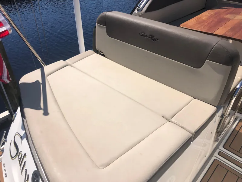 Slide: The Image of 2014 Sea Ray 370 Venture boat with cushioned seating and wooden table. - 44
