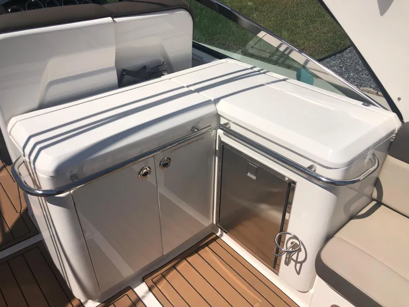 Slide: The Image of 2014 Sea Ray 370 Venture boat interior with sleek cabinetry and stainless steel accents. - 46