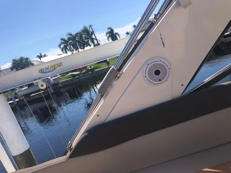 Slide: The Image of 2014 Sea Ray 370 Venture boat interior with water and palm trees in background. - 49