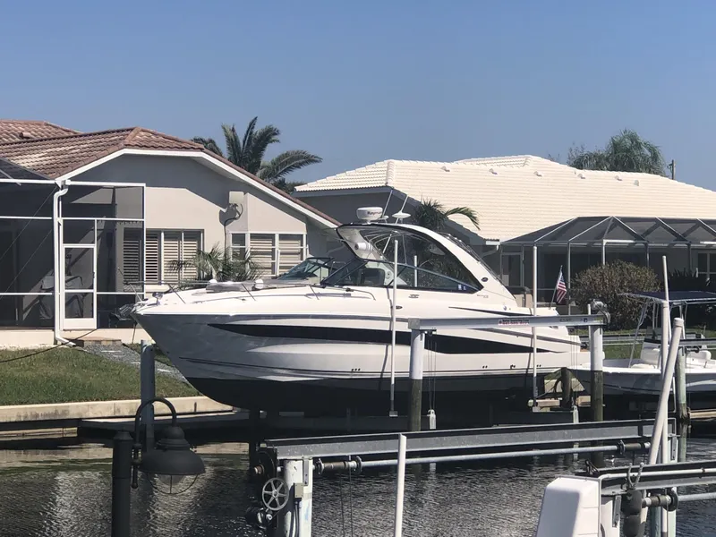 Slide: The Image of 2014 Sea Ray 370 Venture docked by waterfront homes. - 5