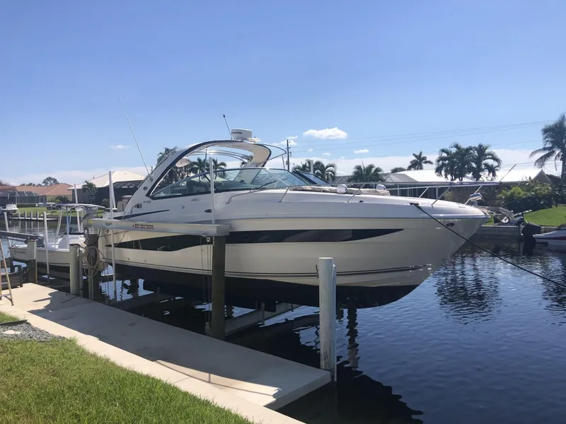 Slide: The Image of 2014 Sea Ray 370 Venture boat docked by a sunny canal. - 6