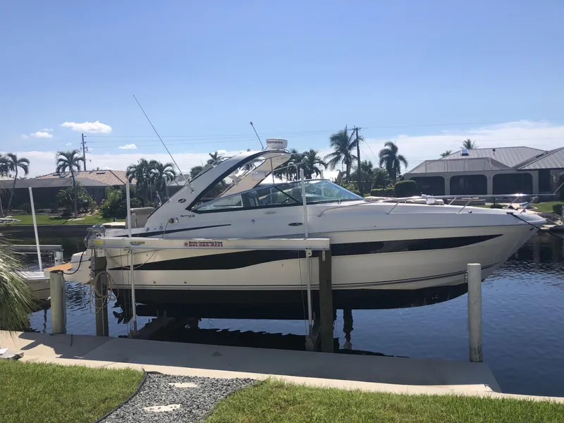 Slide: The Image of 2014 Sea Ray 370 Venture boat docked by waterfront homes. - 7
