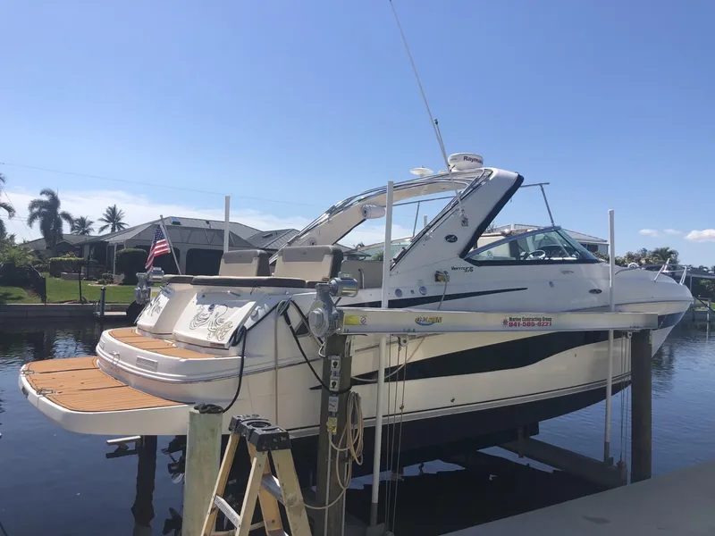 Slide: The Image of 2014 Sea Ray 370 Venture boat docked by waterfront homes. - 9
