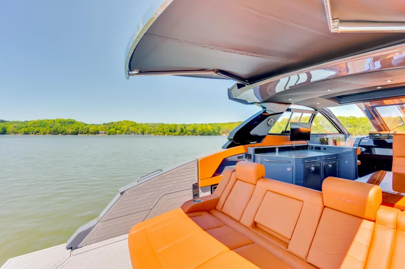 Slide: The Image of 2023 Cruisers Yachts 42 GLS with luxurious seating and scenic lake view. - 13