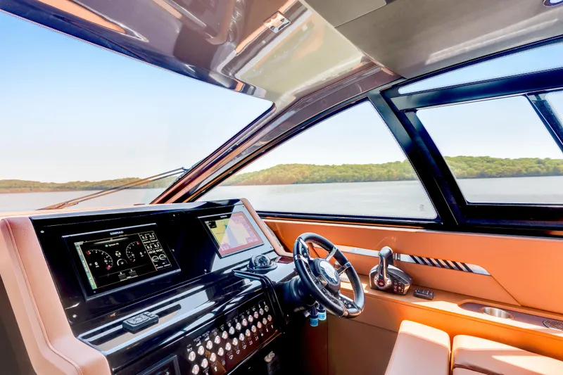 Slide: The Image of 2023 Cruisers Yachts 42 GLS helm with modern controls and scenic water view. - 21