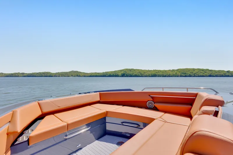 Slide: The Image of 2023 Cruisers Yachts 42 GLS with luxurious seating, overlooking serene waters and lush greenery. - 31