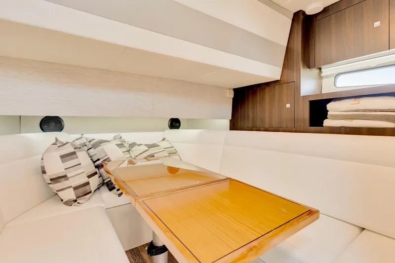 Slide: The Image of 2023 Cruisers Yachts 42 GLS interior with cozy seating and wooden table. - 33