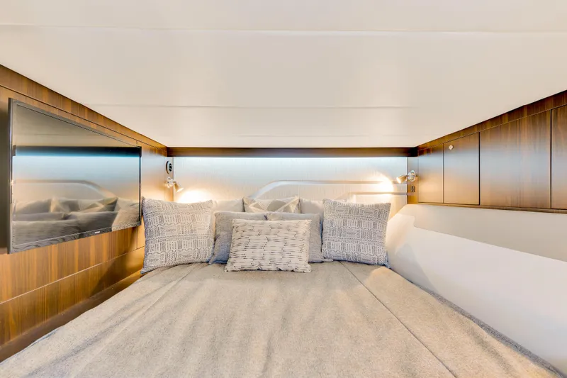 Slide: The Image of Luxurious cabin interior of 2023 Cruisers Yachts 42 GLS with cozy bedding and modern design. - 35