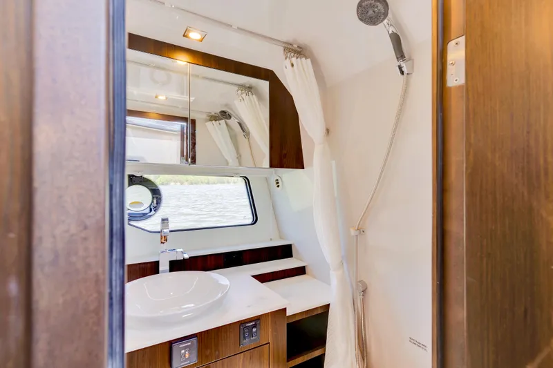 Slide: The Image of Luxurious bathroom interior of 2023 Cruisers Yachts 42 GLS with modern fixtures and window view. - 37