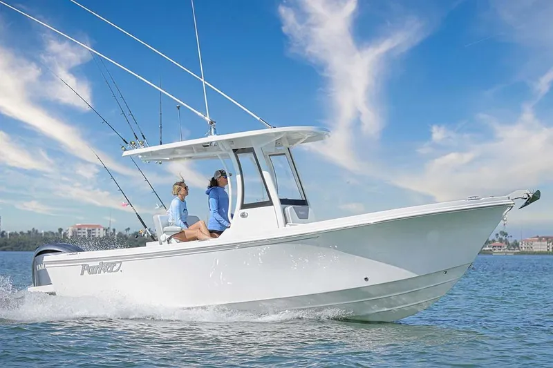The Image of 2025 Parker 2400 Center Console boat in showroom, featuring Yamaha outboard motor. - 0