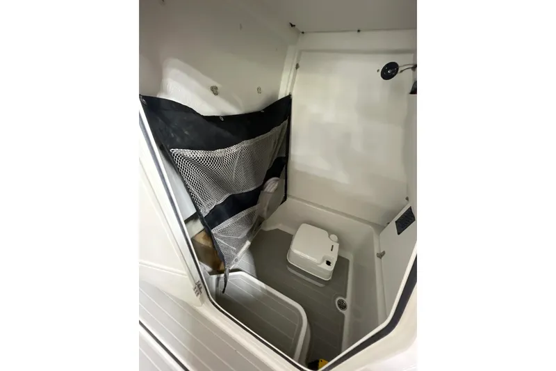 Slide: The Image of Interior of 2025 Parker 2400 Center Console boat with storage and seating area. - 11