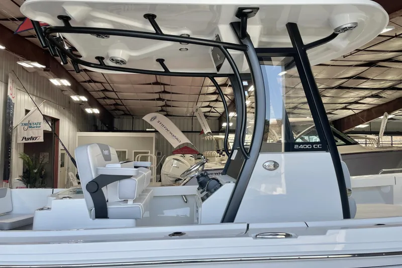 Slide: The Image of 2025 Parker 2400 Center Console boat in showroom, featuring sleek design and modern seating. - 12