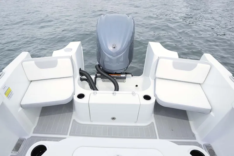 Slide: The Image of 2025 Parker 2400 Center Console boat interior with steering wheel and storage compartment. - 6