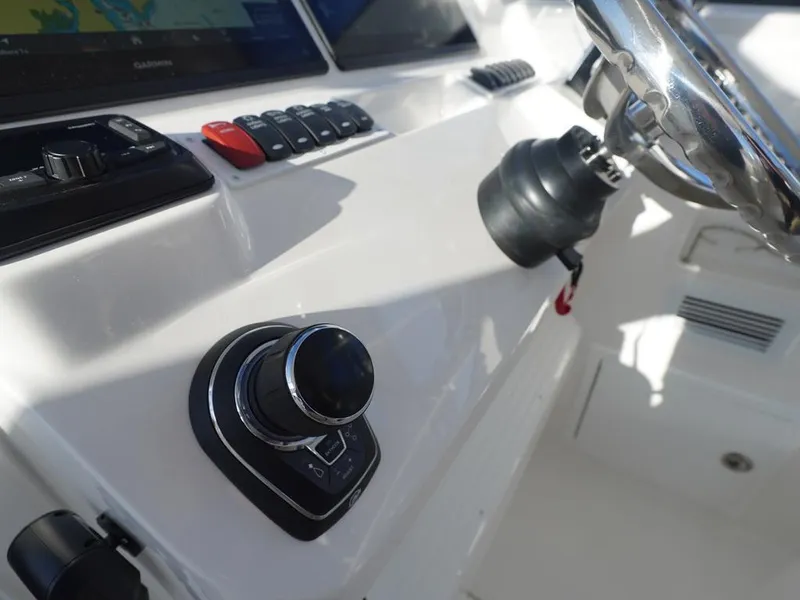 Slide: The Image of 2024 Albemarle 30 Express boat dashboard with steering wheel and control panel. - 11
