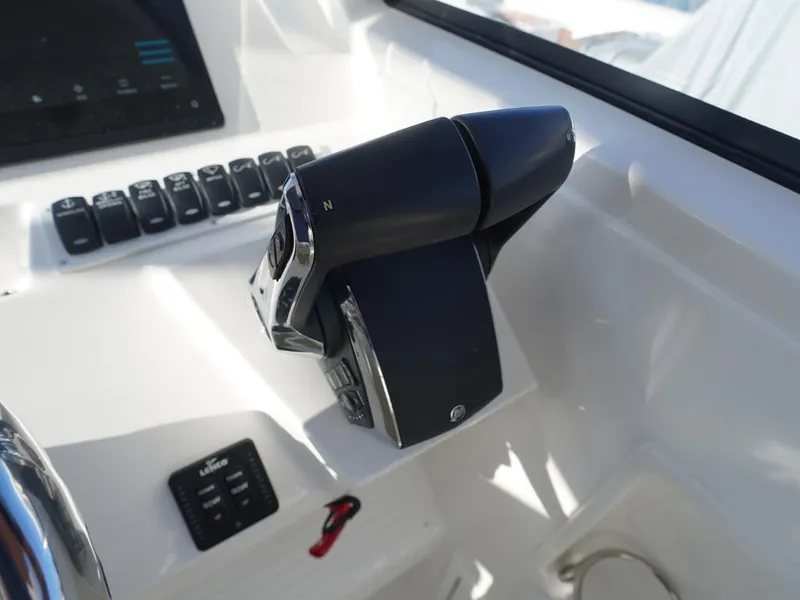 Slide: The Image of 2024 Albemarle 30 Express boat throttle controls and dashboard. - 12