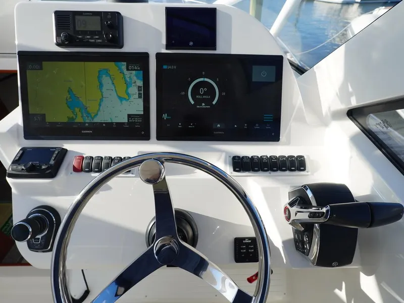 Slide: The Image of 2024 Albemarle 30 Express helm with navigation screens and controls. - 13