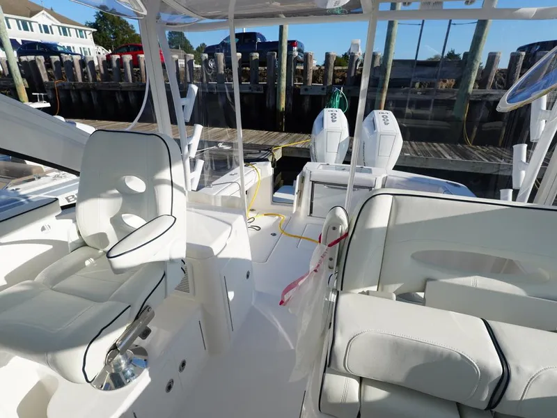 Slide: The Image of 2024 Albemarle 30 Express boat interior with seating and dual engines at dock. - 14