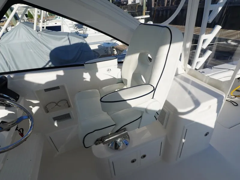 Slide: The Image of 2024 Albemarle 30 Express boat interior with white captain's chair and sleek design. - 16