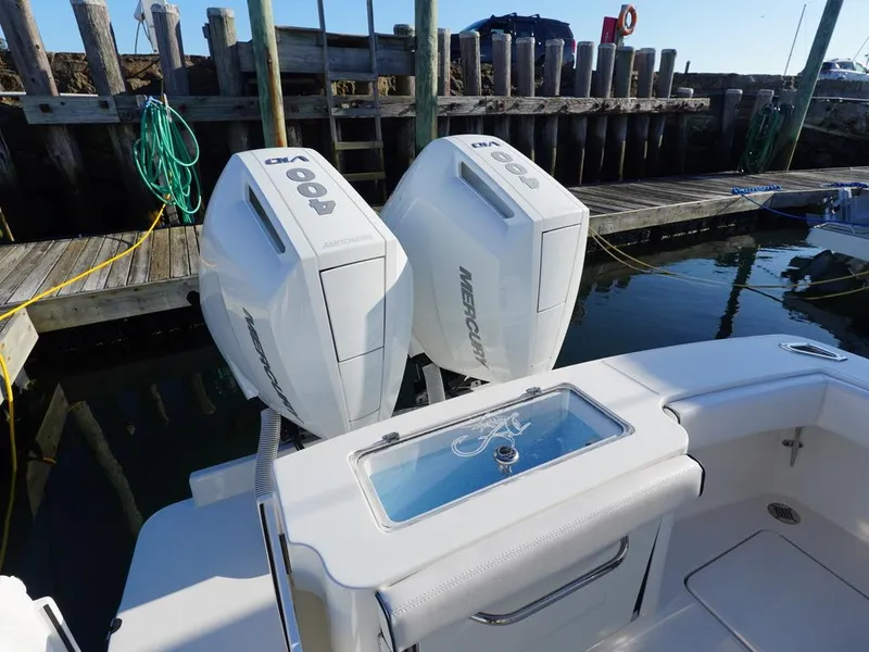 Slide: The Image of 2024 Albemarle 30 Express boat with twin Mercury outboard engines at dock. - 18