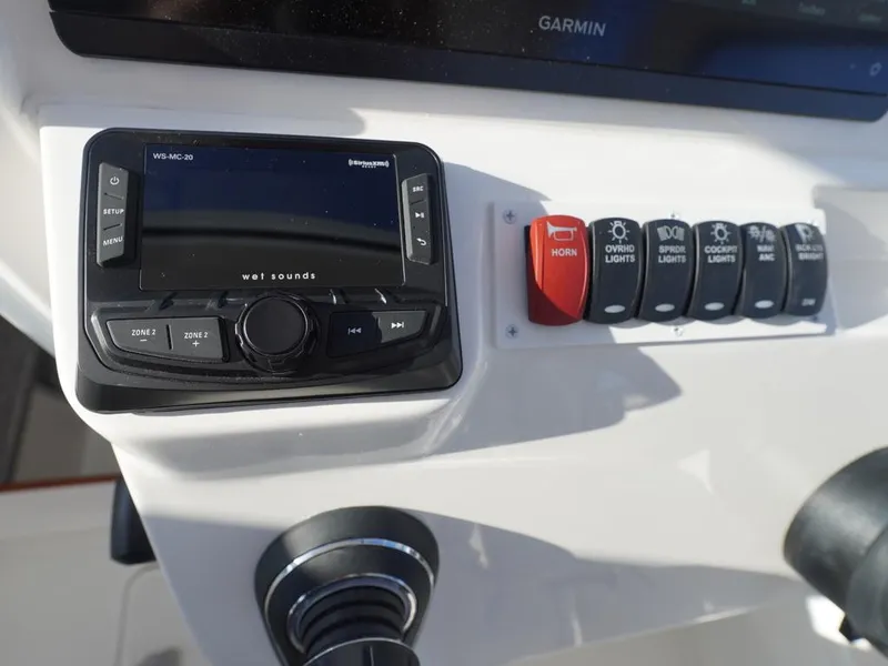 Slide: The Image of Control panel of 2024 Albemarle 30 Express boat with audio system and switches. - 28