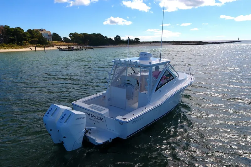 Slide: The Image of 2024 Albemarle 30 Express boat cruising on a sunny day near the shore. - 4