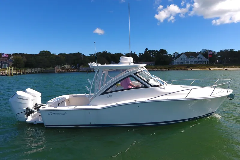 Slide: The Image of 2024 Albemarle 30 Express boat on calm water near shoreline. - 5