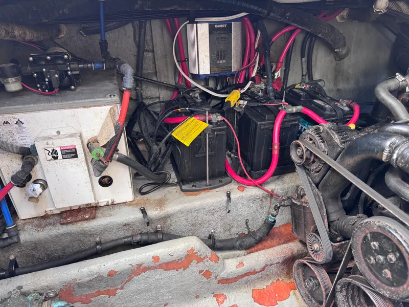 Slide: The Image of Engine compartment of a 2004 Sea Ray 290 Amberjack with visible wiring and components. - 13