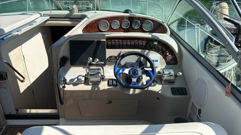 Slide: The Image of 2004 Sea Ray 29 Amberjack boat helm with steering wheel and control panel. - 2