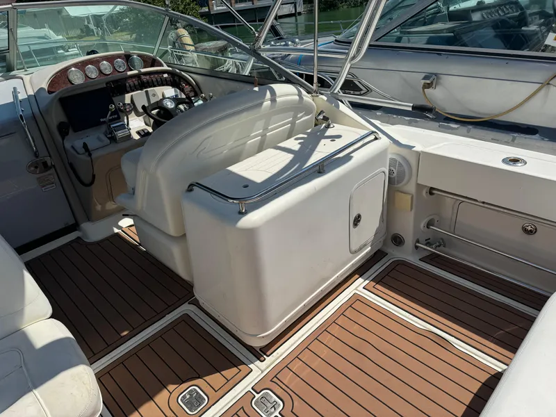 Slide: The Image of 2004 Sea Ray 29 Amberjack boat interior with wood flooring and steering console. - 3