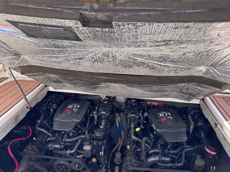 Slide: The Image of 2004 Sea Ray 290 Amberjack engine compartment with dual engines visible. - 6