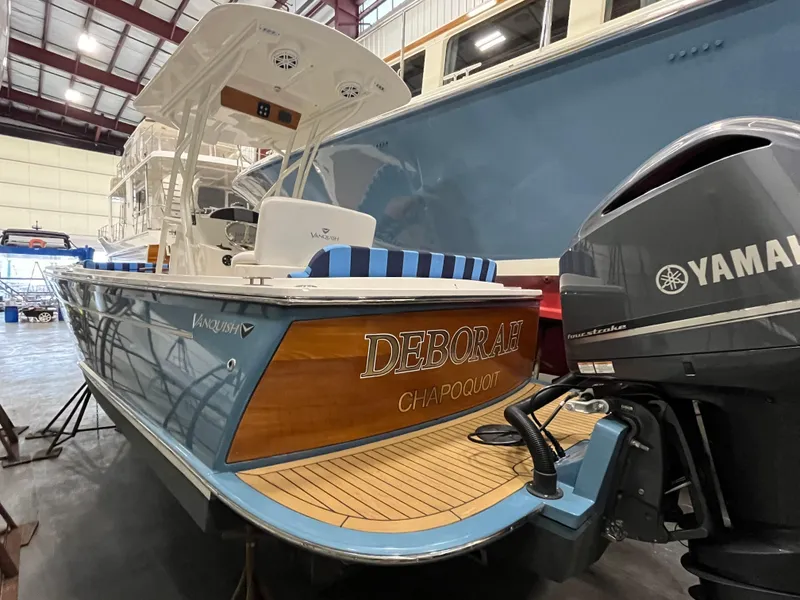 Slide: The Image of 2021 Vanquish 26 boat with Yamaha engine in a storage facility. - 0