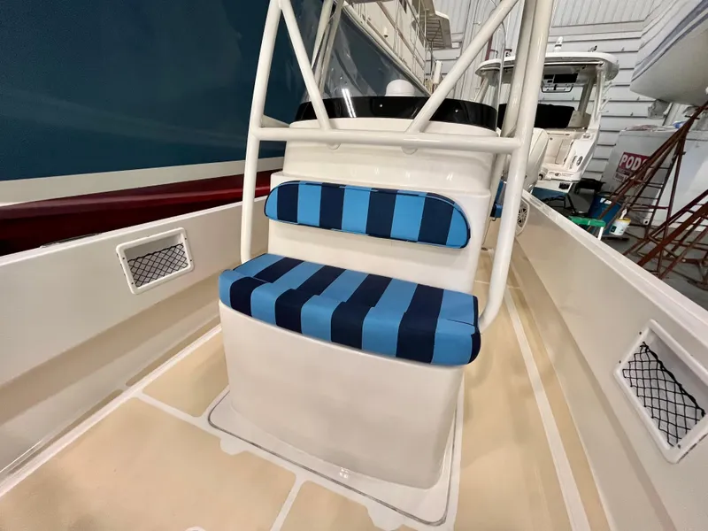 Slide: The Image of Vanquish 26 boat interior with blue striped seating, 2021 model. - 11