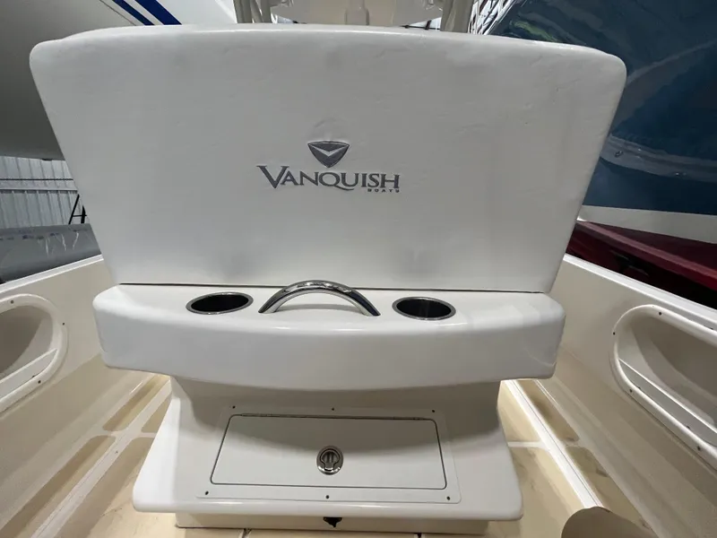 Slide: The Image of 2021 Vanquish 26 boat interior with logo and cup holders. - 19