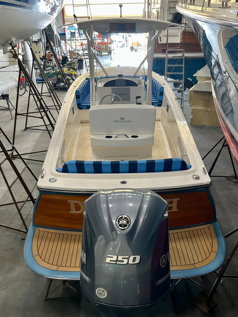 Slide: The Image of 2021 Vanquish 26 boat with Yamaha 250 engine in a storage facility. - 23