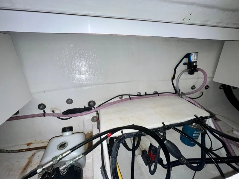 Slide: The Image of Engine compartment of 2021 Vanquish 26 boat with visible wiring and components. - 26