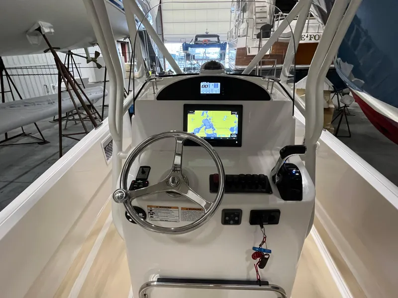Slide: The Image of Vanquish 26 boat dashboard with steering wheel and navigation display, 2021 model. - 3