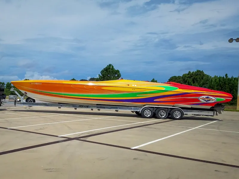 Slide: The Image of 2005 Outerlimits 51 Sport Yacht with vibrant, colorful design on a trailer. - 10