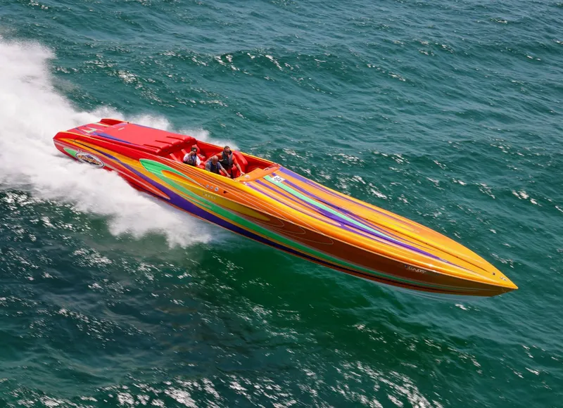 Slide: The Image of Colorful 2005 Outerlimits 51 Sport Yacht speeding on open water. - 11