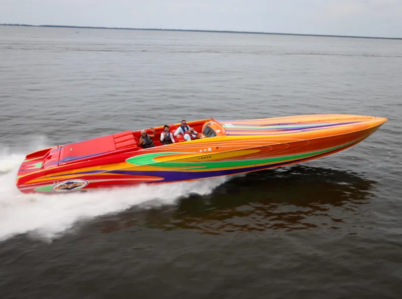 Slide: The Image of 2005 Outerlimits 51 Sport Yacht speeding on water, vibrant multicolor design. - 2