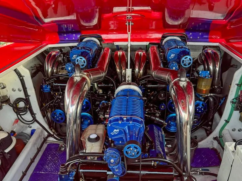 Slide: The Image of Engine compartment of 2005 Outerlimits 51 Sport Yacht with polished components and blue accents. - 5