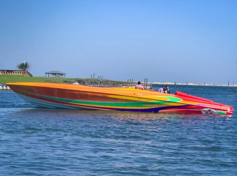 Slide: The Image of Colorful 2005 Outerlimits 51 Sport Yacht on calm water. - 6