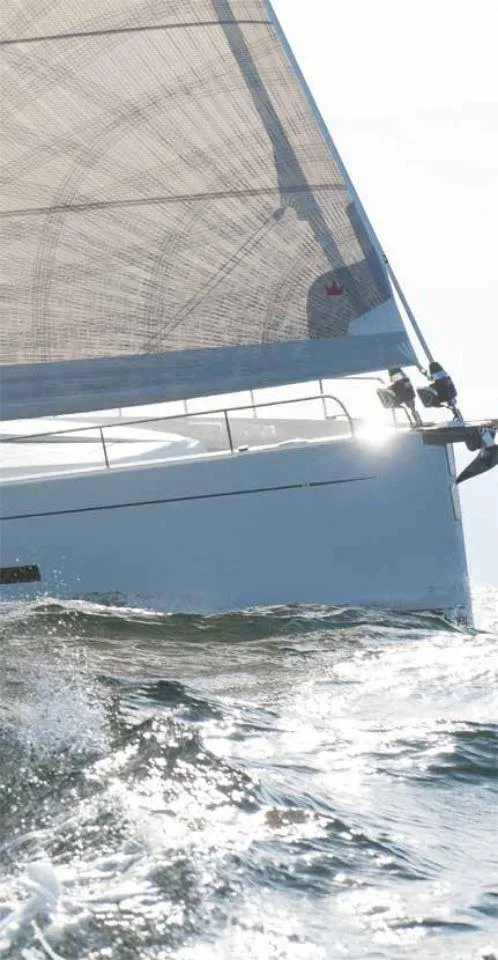 Slide: The Image of Sailing yacht Moody 41 DS 2025 gliding through ocean waves, sunlit sail. - 11
