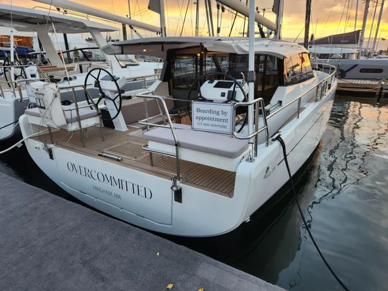Slide: The Image of Sailing yacht Moody 41 DS, 2025 model, docked at sunset with "Overcommitted" nameplate. - 13